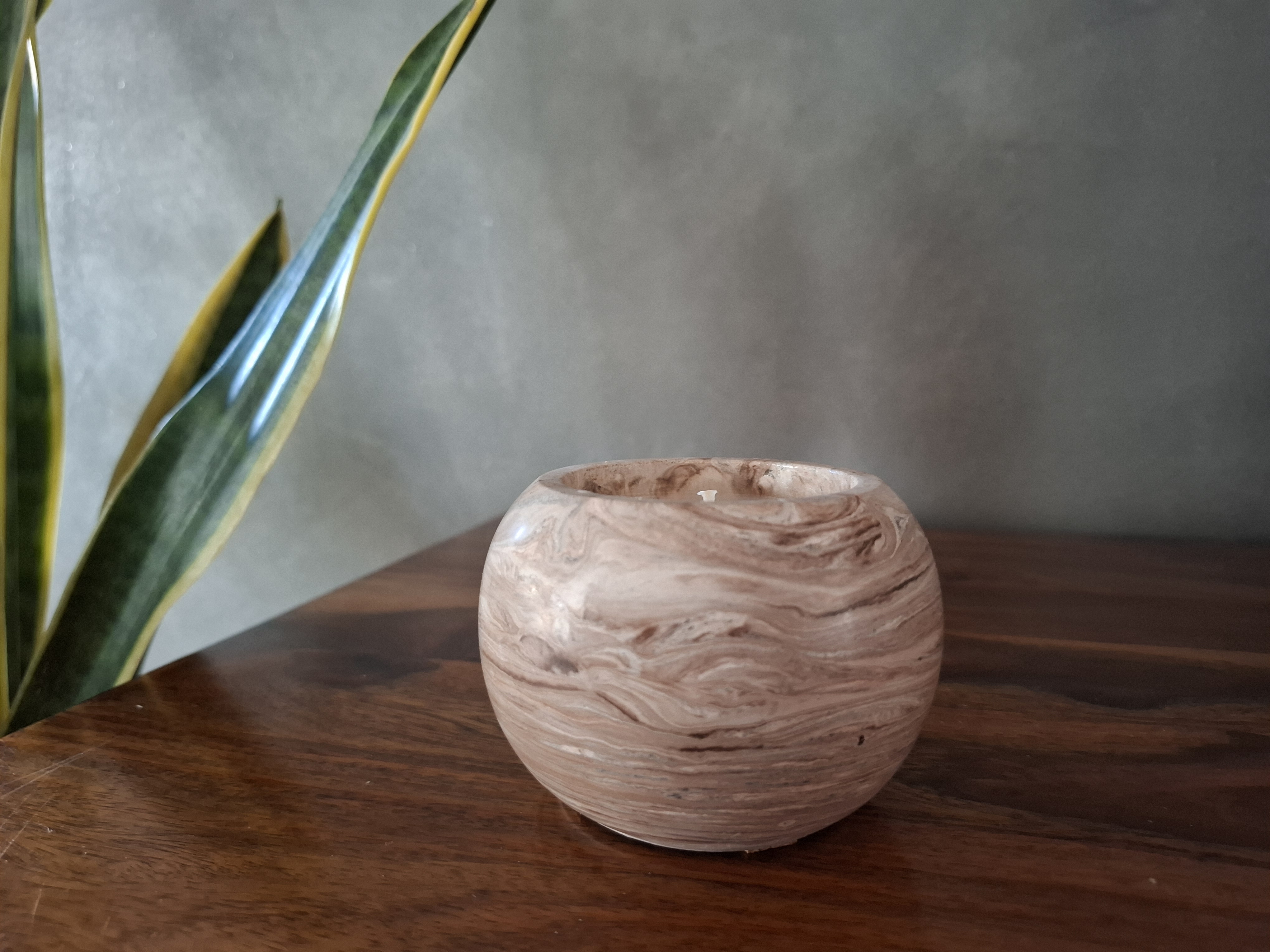 Minimalist handmade candle in gypsum container, sustainable soy wax.