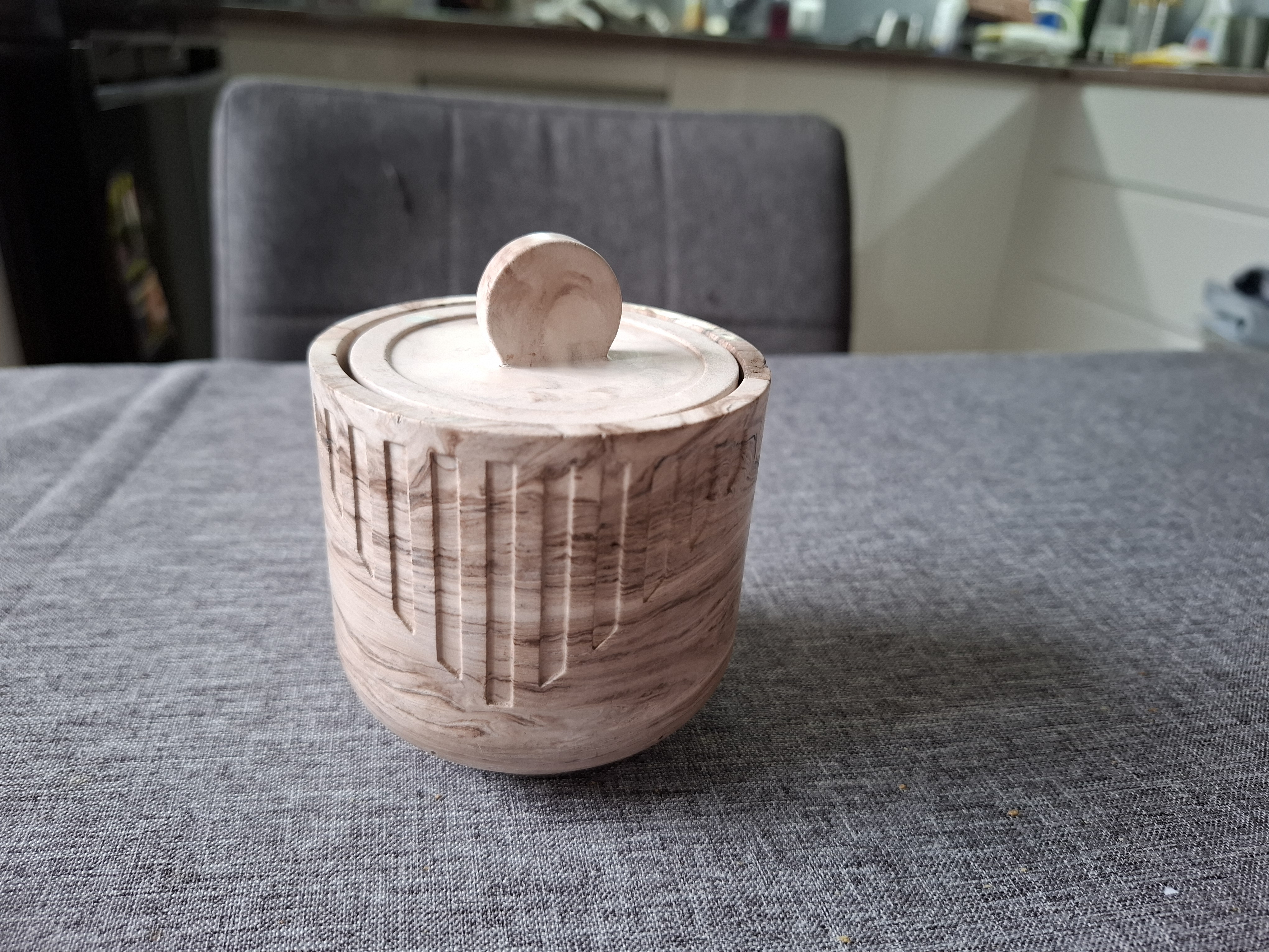 Minimalist handmade candle in gypsum container, sustainable soy wax.
