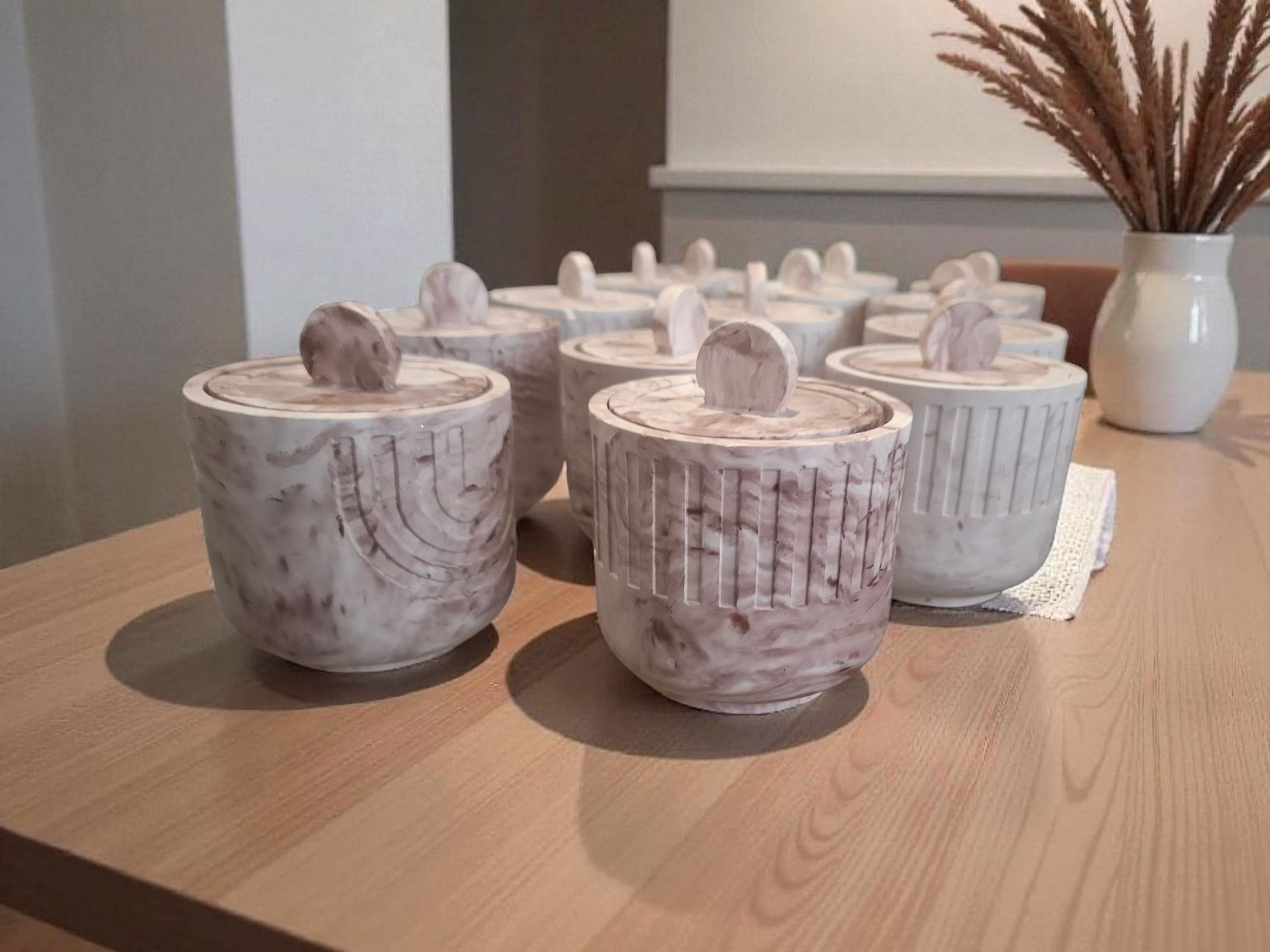 Minimalist handmade candle in gypsum container, sustainable soy wax.