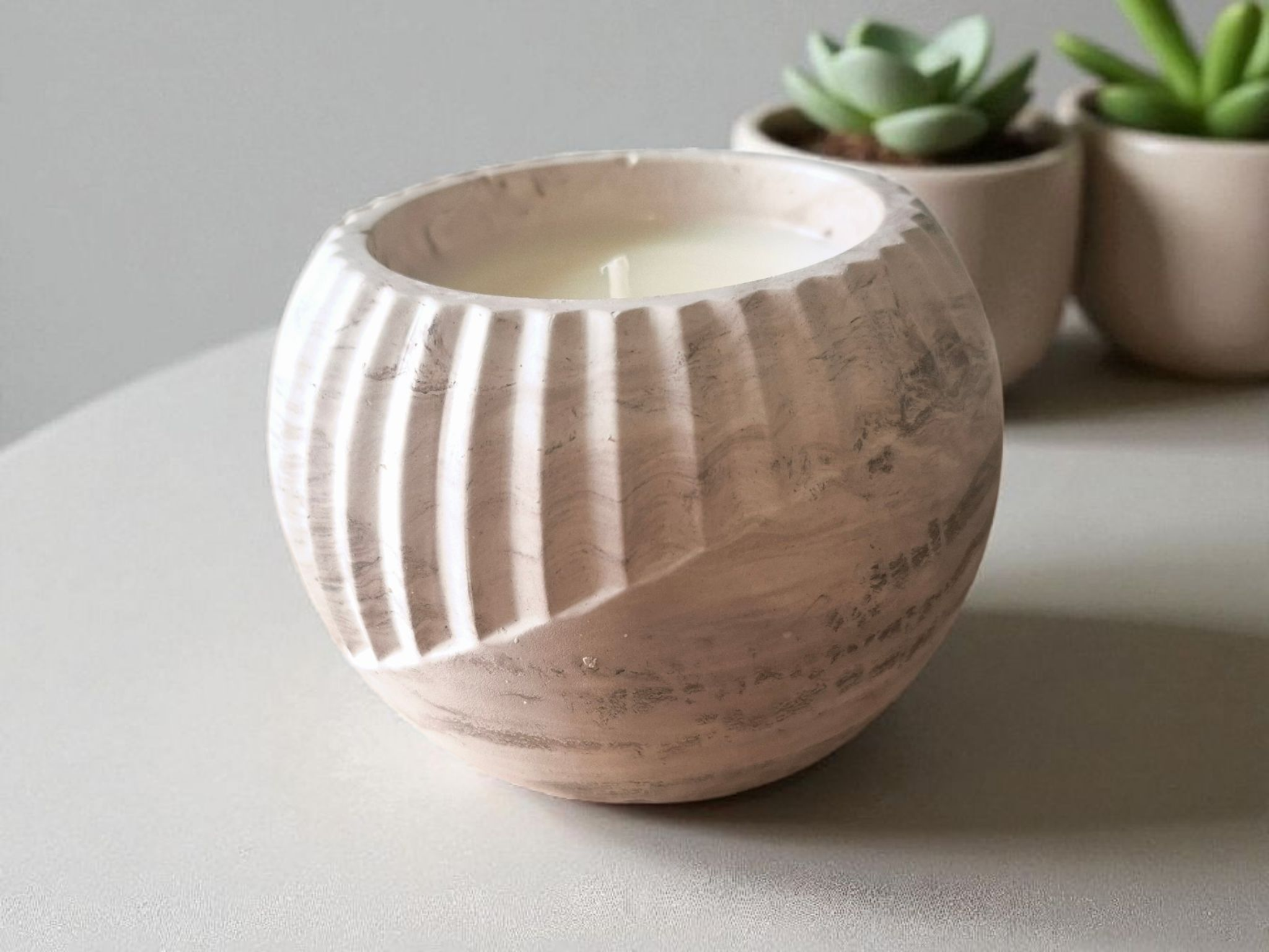 Minimalist handmade candle in gypsum container, sustainable soy wax.